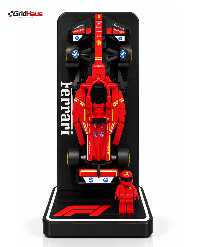A red Ferrari Formula 1 toy model displayed on a black stand, with a small red driver minifigure in front. The display features the word 'Ferrari' in white on the side and a 'GridHaus' logo in the top-left corner.